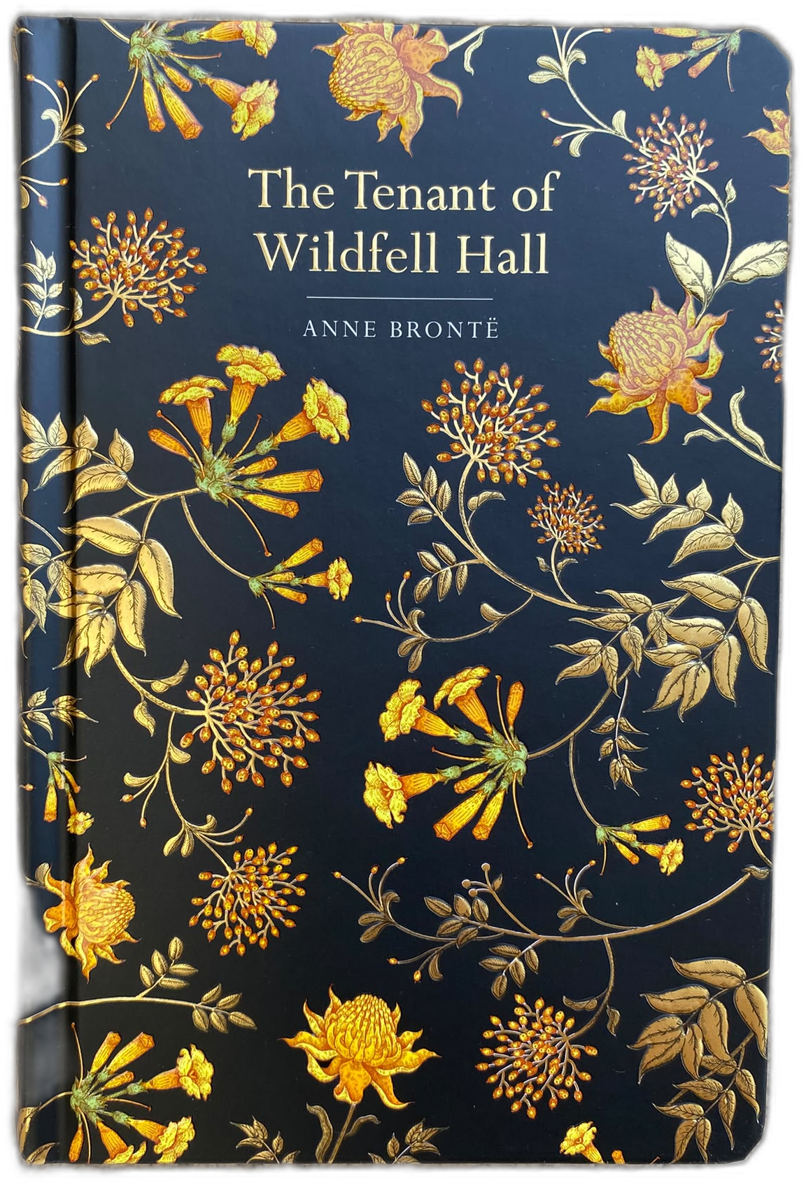 The Tenant of Wilden Hall book cover by Anne Bronte, featuring a dark navy blue background with an intricate gold and beige floral pattern and white text.